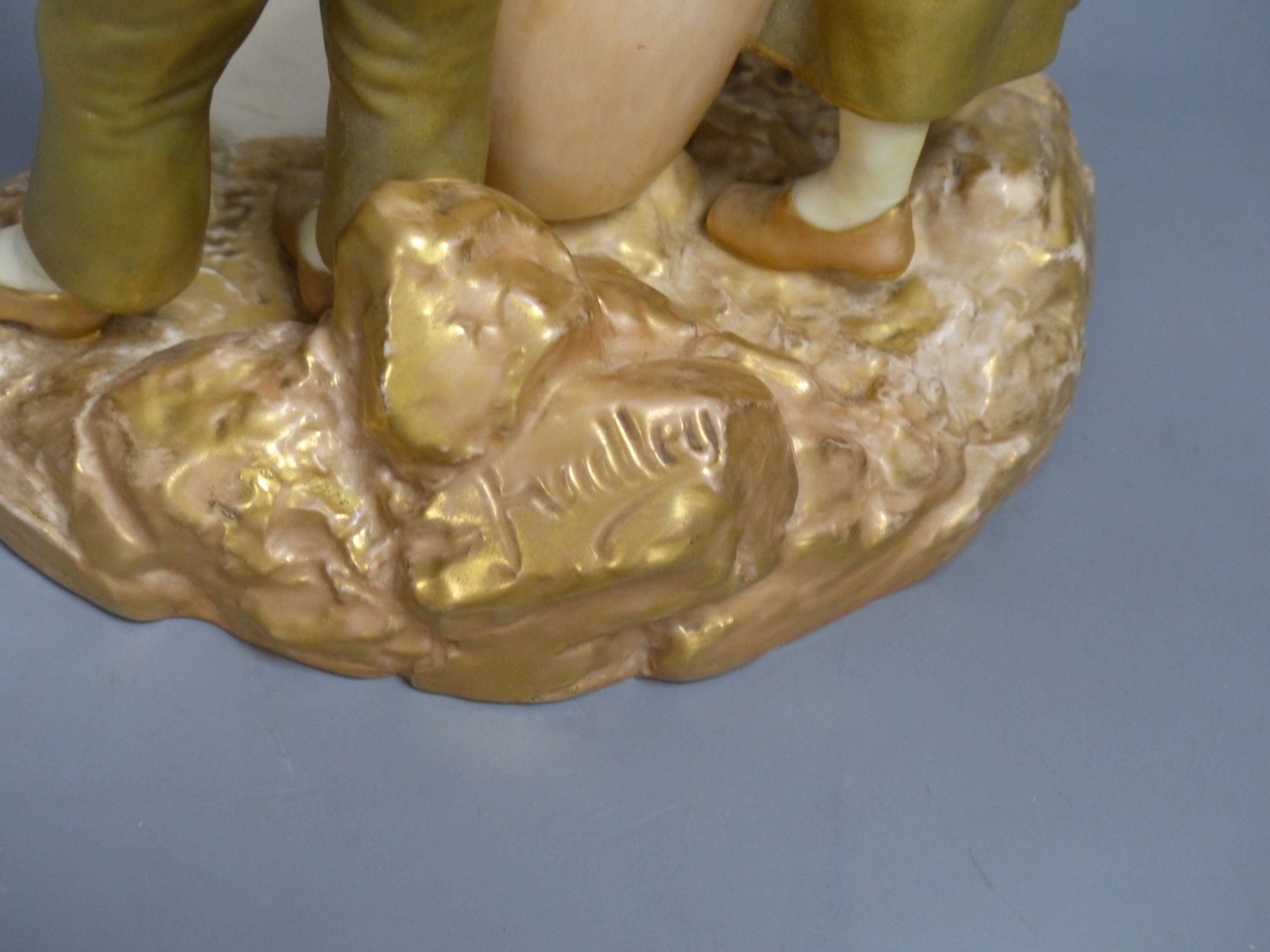 A Royal Worcester group of a boy and a girl, date code for 1917, height 24cm